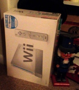 a Nintendo Wii photographed on the floor of my childhood bedroom, next to a nutcracker that I'd pulled out to decorate for Christmas with